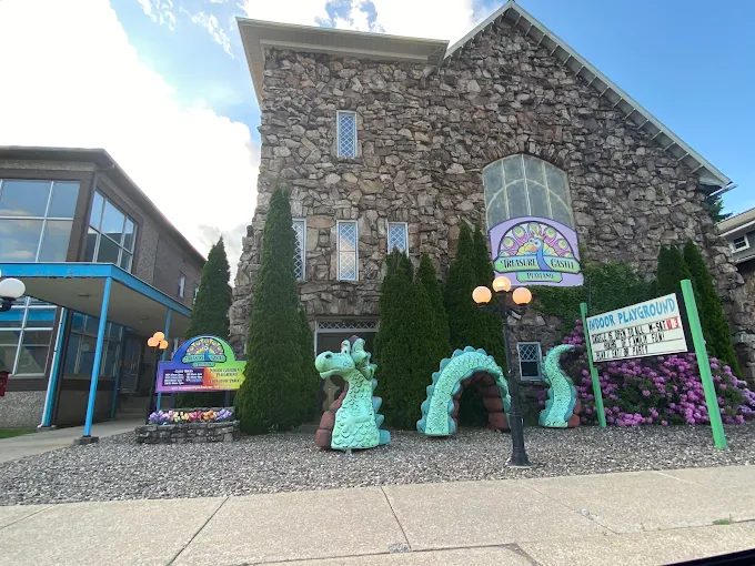 The Treasure Castle stone building with its teal sea serpent sculpture and playland sign out front