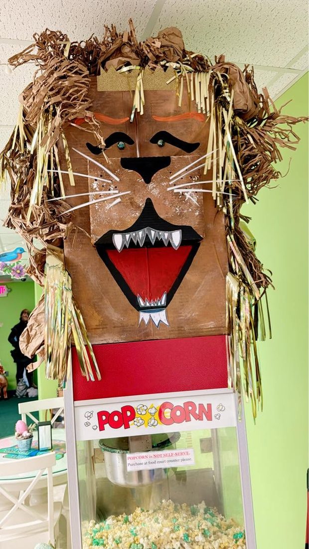 The Castle's kettle corn popcorn machine topped with a paper lion