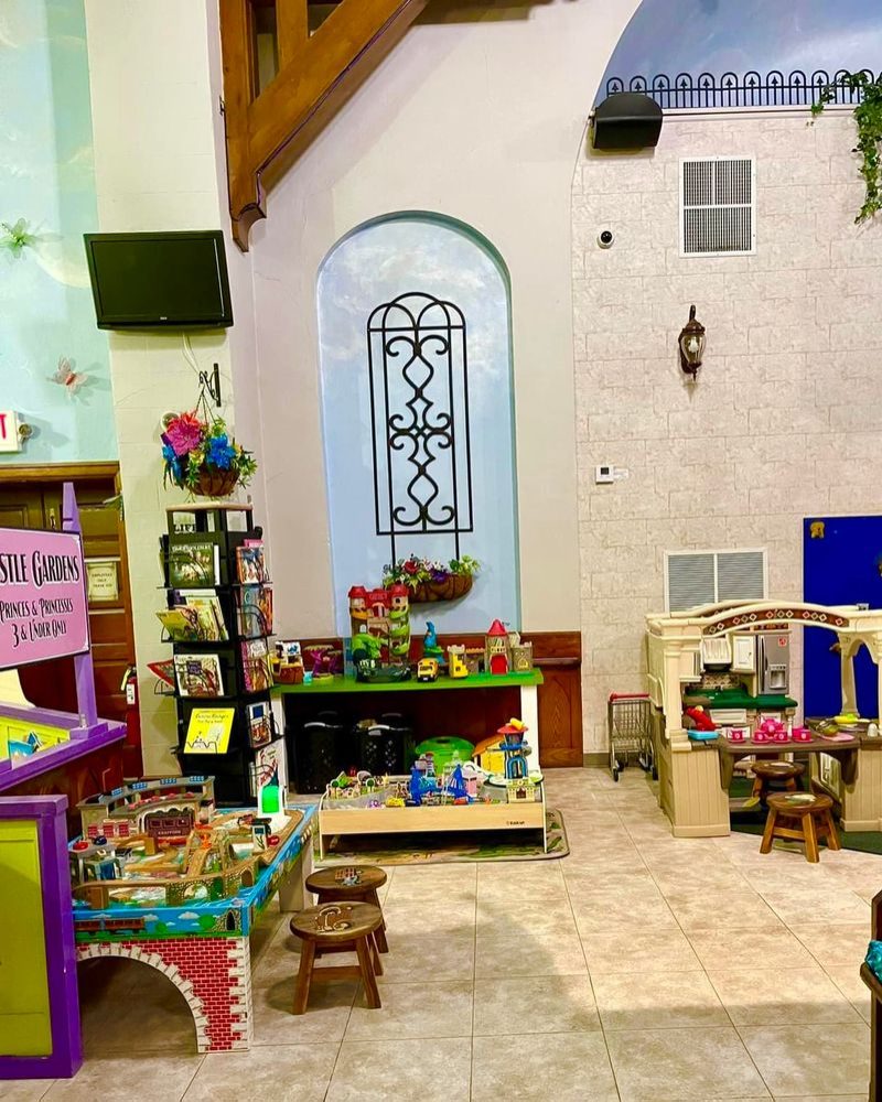 The Toddler Garden of Eden play area with a play kitchen and train table